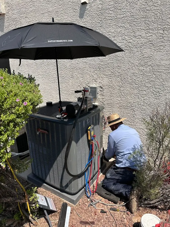 HVAC technician performing outdoor AC maintenance in Crookston